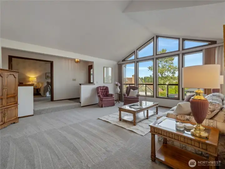 Across the hall from the living room you will find the entrance to the primary suite with it's elegant double doors.