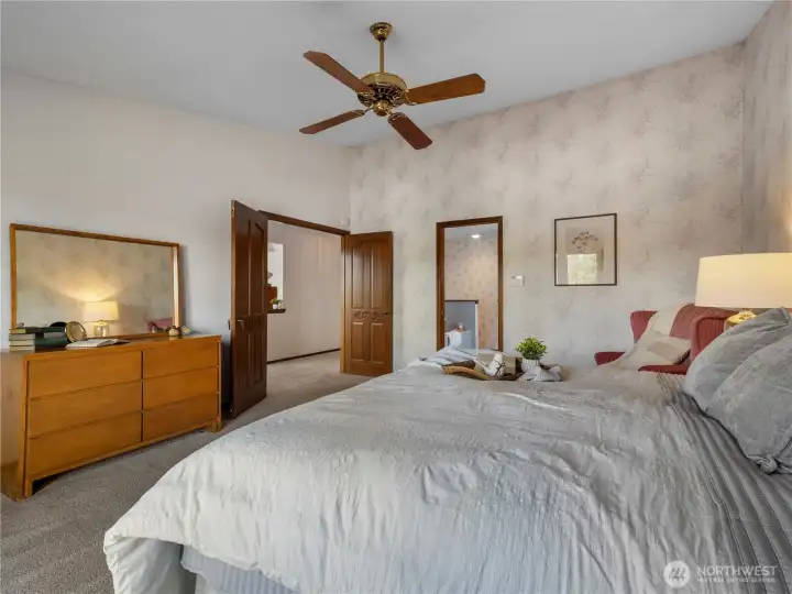 The primary suite has vaulted ceilings and large windows.