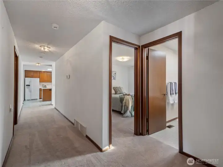 Down the hall from the primary suite you will find the other 2 bedrooms and main bathroom.