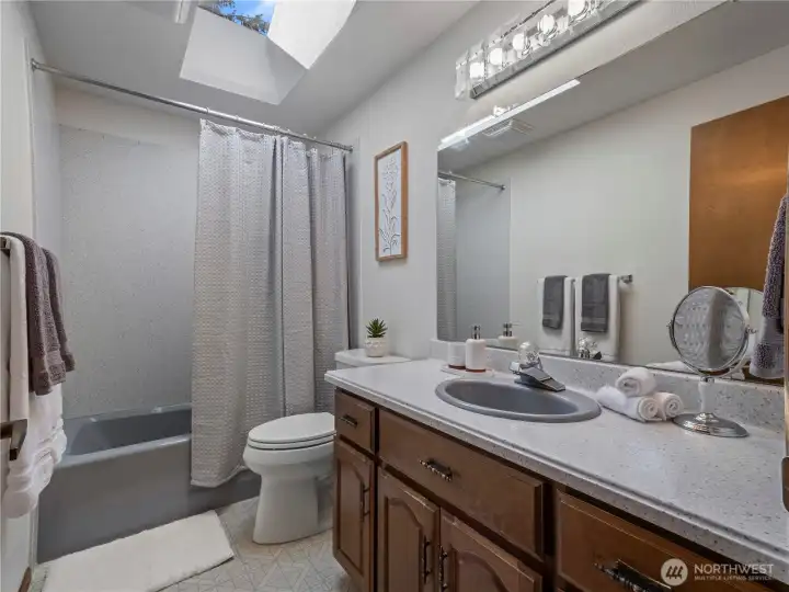 Between the two rooms youll find the main bathroom with a large skylight.