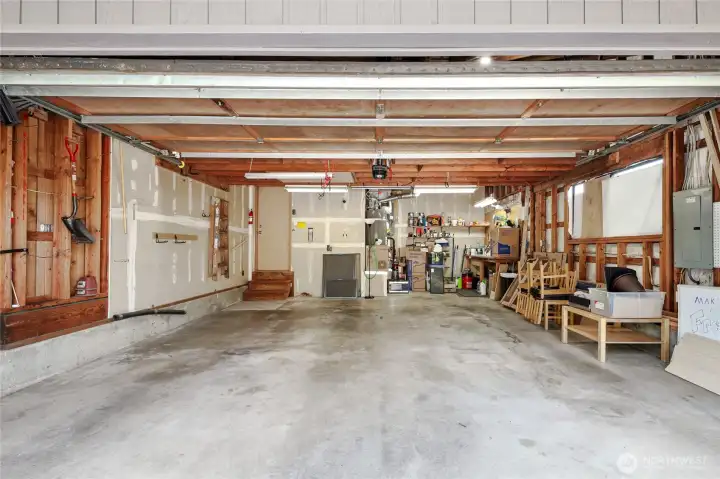 Two car garage with ample storage and work space.