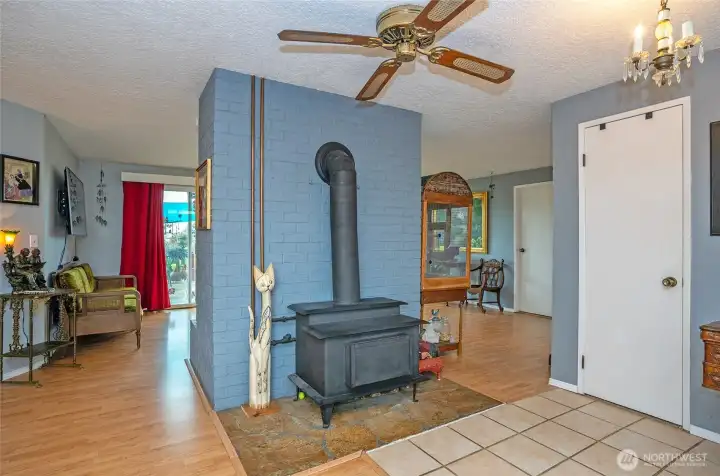 This free standing wood stove also heats the water. There is a traditional wood fireplane on the other side.