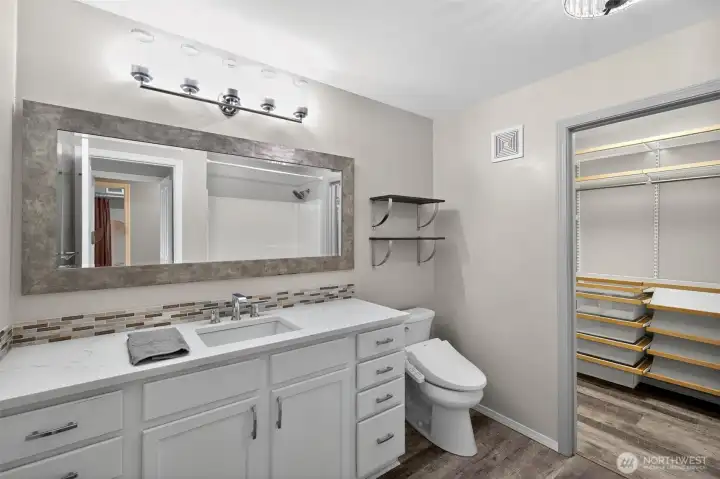 Primary ensuite bathroom with walk-in closet