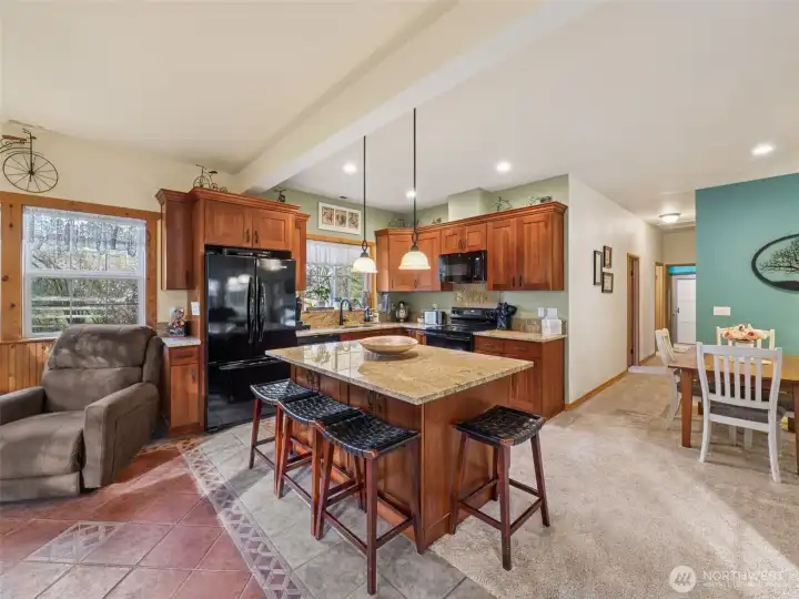 Kitchen features granite countertops, a new stove & microwave & convenient breakfast bar.
