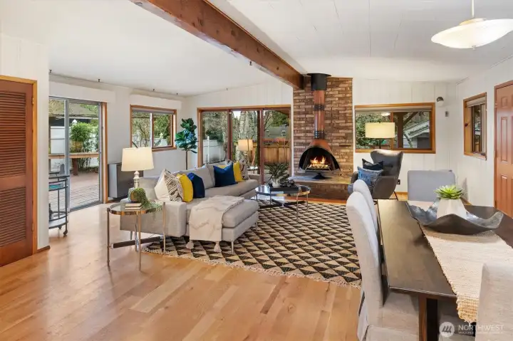Visually anchored by a mid-century classic fireplace, with easy access to the back and side yards!