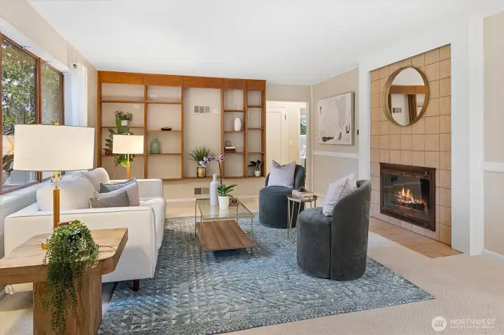 This large formal living room (over 300sf) features a fireplace and display shelving!