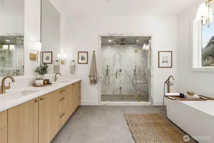 Upstairs primary retreat featuring a double–shower head steam shower, stunning fluted soaking tub, and two closets.