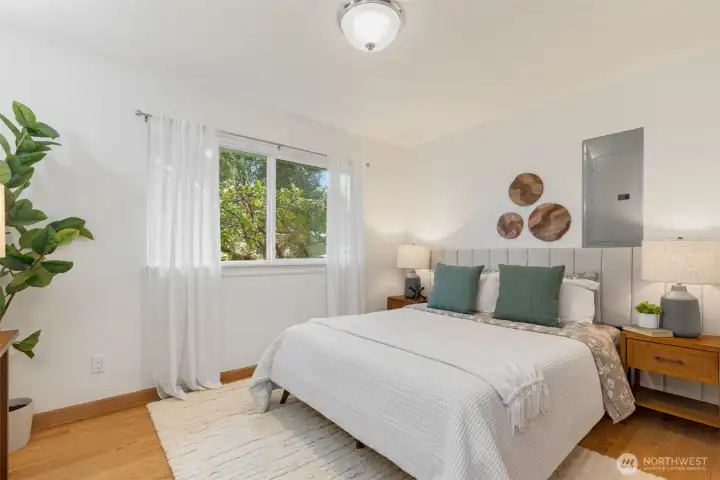 Primary bedroom with views of the front yard.