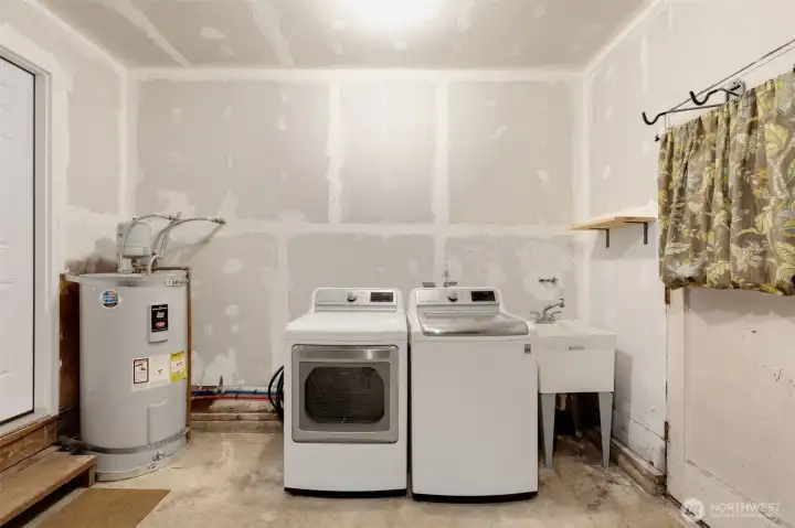 Laundry & hot water tank in the garage