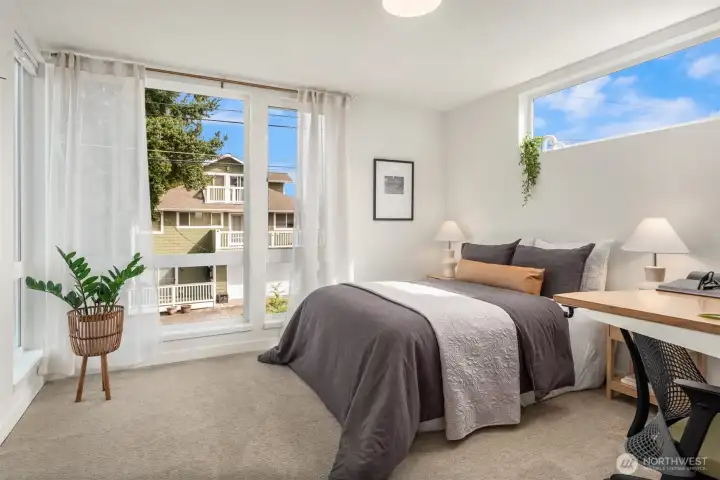 Up the first flight of stairs is the 2nd bedroom. Each bedroom is on its own floor and has its own bath, which means the home lives beautifully whether the buyer wants an elevated guest setup, roommate flexibility, a polished work-from-home arrangement, or simply some breathing room.