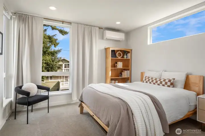 The top-floor primary suite feels like a proper retreat with great natural light, downtown views, and a spa-like bath with a walk-in rain shower.