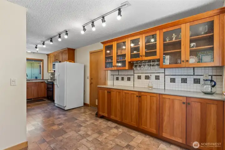 A bank of cabinets for storage, coffee station and wine storage
