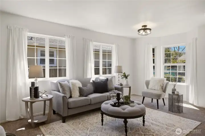 Upon entry to the home, you'll find a warm and welcoming living room. Large windows draw in lots of natural light!