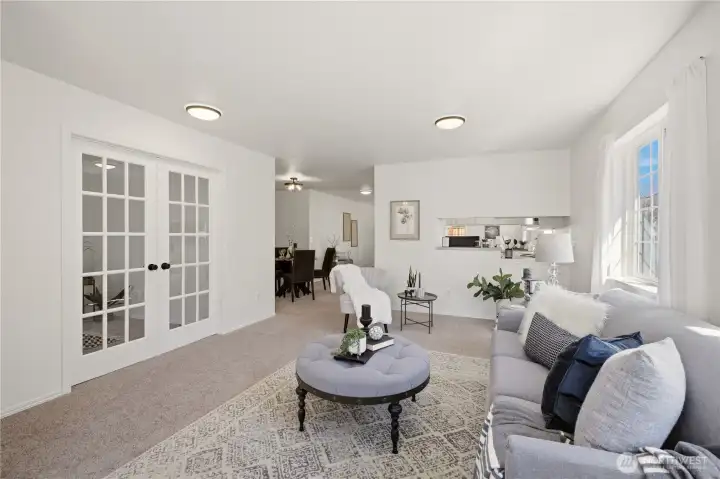 Adjacent to the living room, through the French doors, is a bedroom that can also serve as a home office or hobby room.