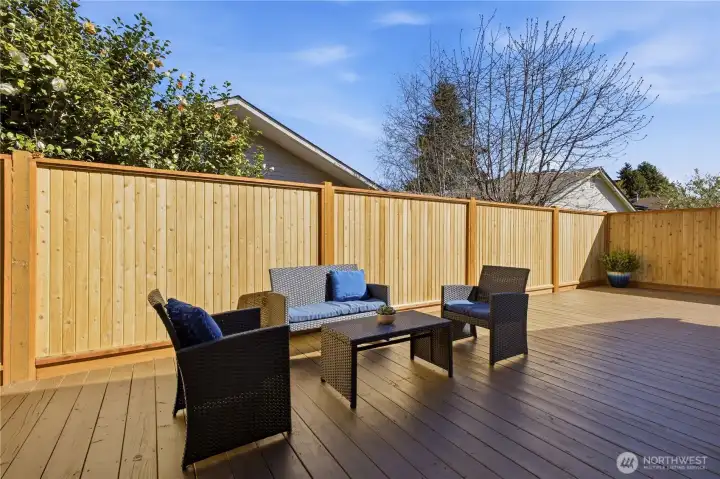 Stepping out to the back deck, you'll find a lovely spot for relaxing, hosting a BBQ, or growing a potted herb garden.
