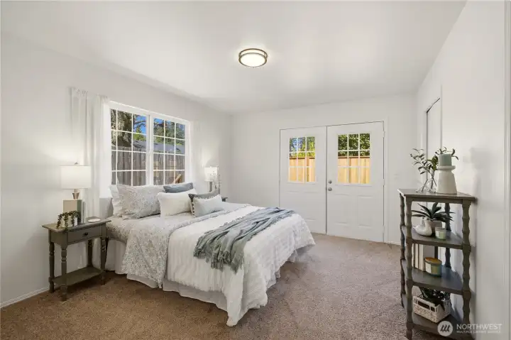 Tucked in the back corner of the home is the spacious primary suite, with doors leading out to the back deck.