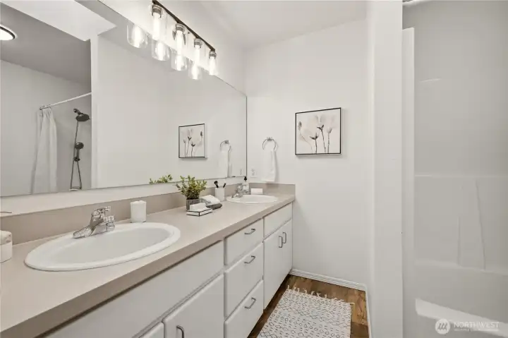 Enjoy a dual sink vanity and wall-to-wall mirror in this private primary bath. Plenty of storage in the vanity!