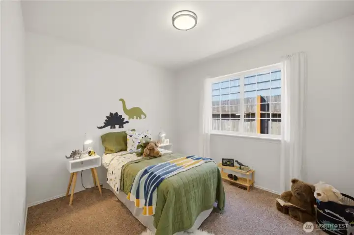 The third bedroom of the home is located down the hall from the primary suite. It's ideal as a kid's room or guest room.