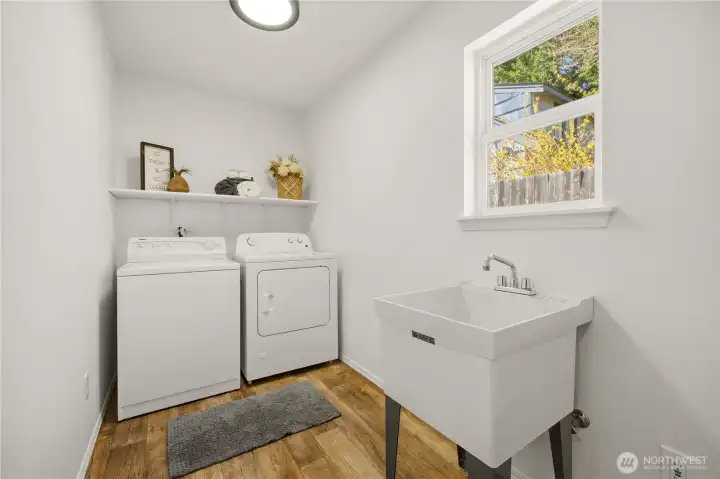 This fantastic laundry room offers abundant space for shelves, hooks, and storage! The washer and dryer stay with the home.