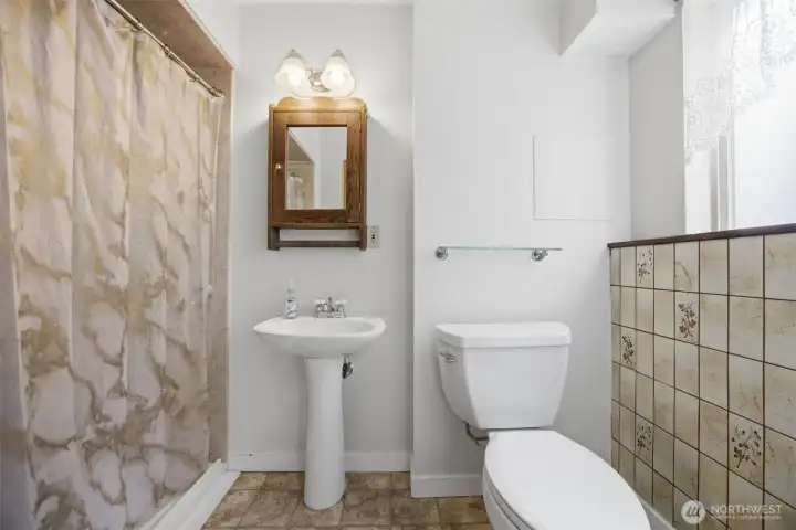 Guest bathroom located on lower level featuring a zero entry shower.