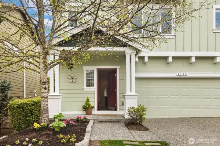 A welcoming covered front porch and beautifully tended entry set the tone for the lifestyle this home offers—warm, inviting, and effortlessly comfortable. Framed by blooming landscape and classic Craftsman detailing, the approach feels both charming and refined. Morning coffee on the porch, neighbors passing by, a sense of arrival each time you come home—this is the kind of everyday living buyers hope to find. Thoughtful curb appeal, timeless character, and a gracious entry create a first impression that feels as special as the home itself.