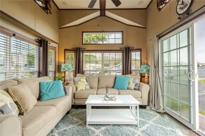 Filled with natural light and vaulted ceilings, this open floor plan feels spacious and inviting. All furniture is included in the sale.