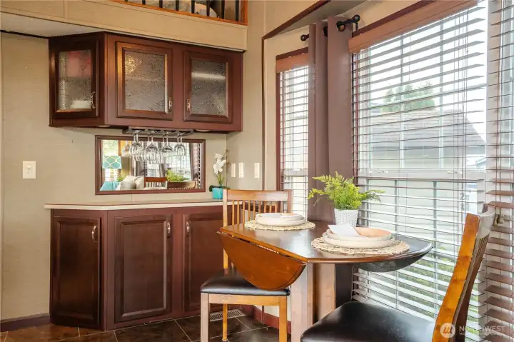 Dining area off the kitchen has built in storage.