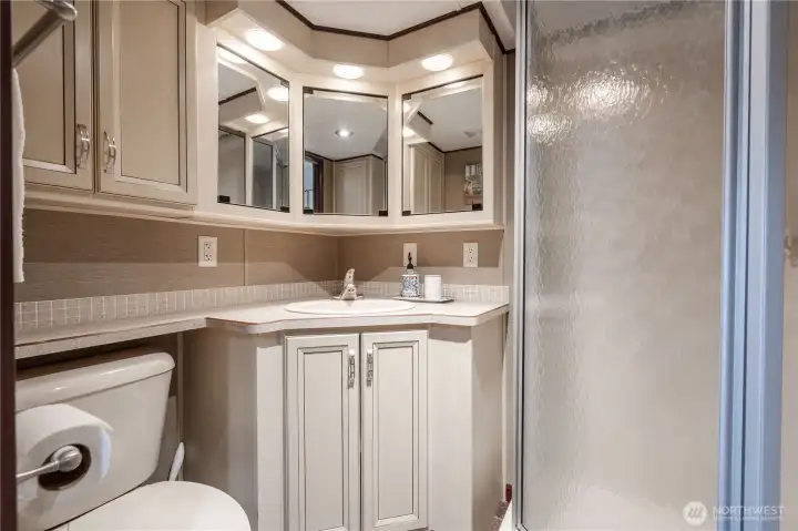Three quarter bath has plenty of storage.