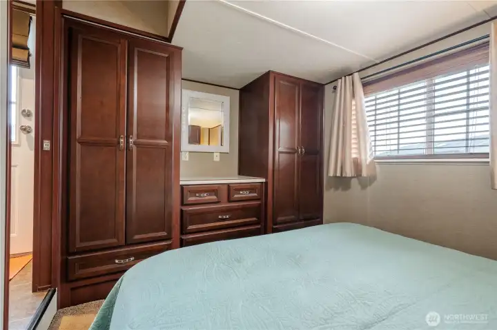 Ample built in storage in the primary bedroom .