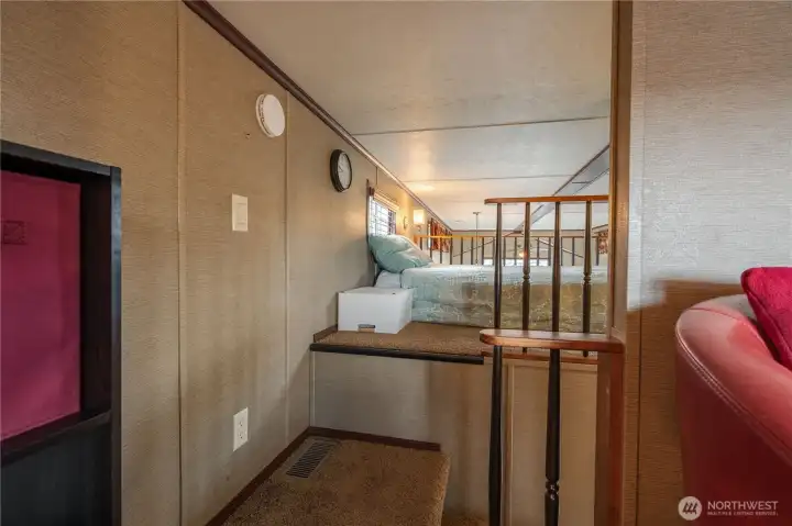 Standing in the den and looking toward the loft bedroom.