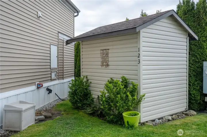 A spacious storage shed sits on the back of the lot behind the home,