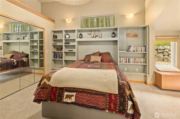 Comfortable bedroom featuring built-in shelving for added character and storage.