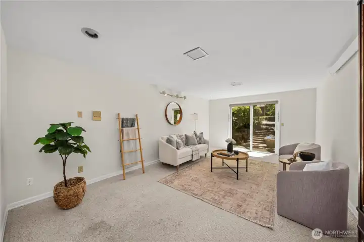 The family room has a sliding glass door that is easily accessible from the side parking and walkways. The family room has a sliding glass door that is easily accessible from the side parking and walkways.