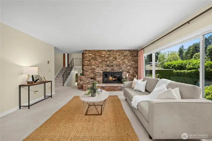 Stairs to the upper level create a territorial view from this fireside living room. Stairs to the upper level create a territorial view from this fireside living room.