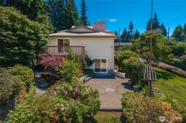 This view of the side yard shows the upper deck and lower patio. This view of the side yard shows the upper deck and lower patio.