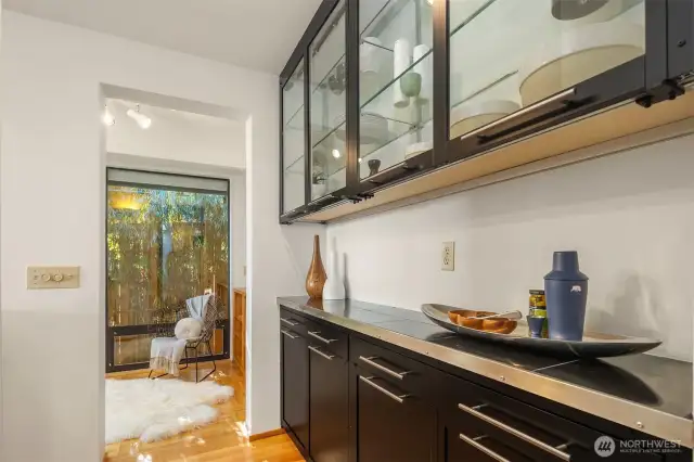 Mature bamboo delivers a Zen privacy screen in the breakfast nook/office.  Directly behind us is another office, the door to the garage, primary bedroom, and full bath; as well as the stairs to the lower level.