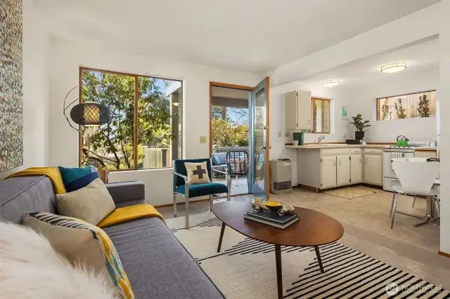 The cute kitchen has room for a little bistro table, and enjoys lovely light thanks to abundant windows.