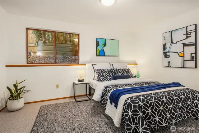 The size, ceiling height, and oversized window combine to make this lower bedroom very gracious.