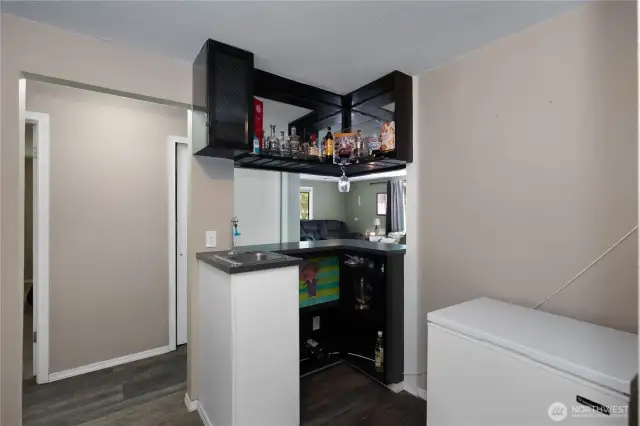 Wet bar that flows sleamlessly into living room.