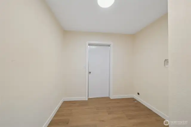 Large laundry room with door to back.