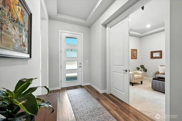 Grand entryway with 10' tray ceilings. Double doors to office or flex space