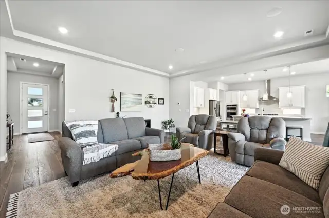 Living room with tray ceiling and built-in speakers