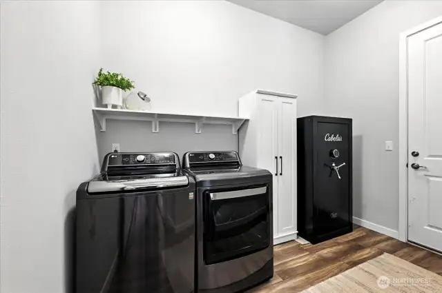 Large laundry room off of garage. Garage has 4' extension with insulated walls and includes EV charger, tankless water heater,  wired for generator and additional storage shelving.