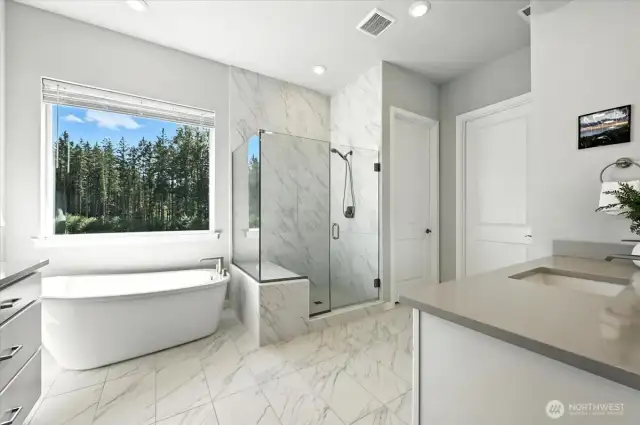 Walk-in shower with tile bench and frameless glass