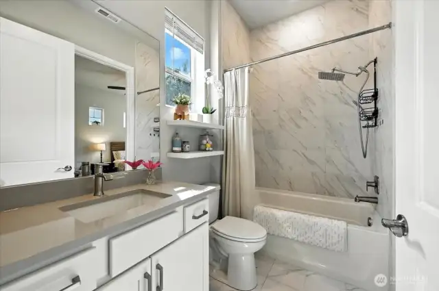 Jack-and-Jill bath with Quartz counters and tiled shower