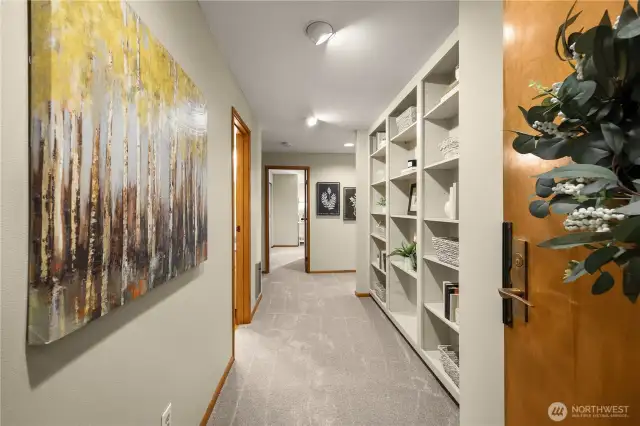 Entry way with a large closet to the right and built in bookcases for storage.