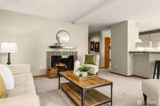 Open living room with wood fireplace.