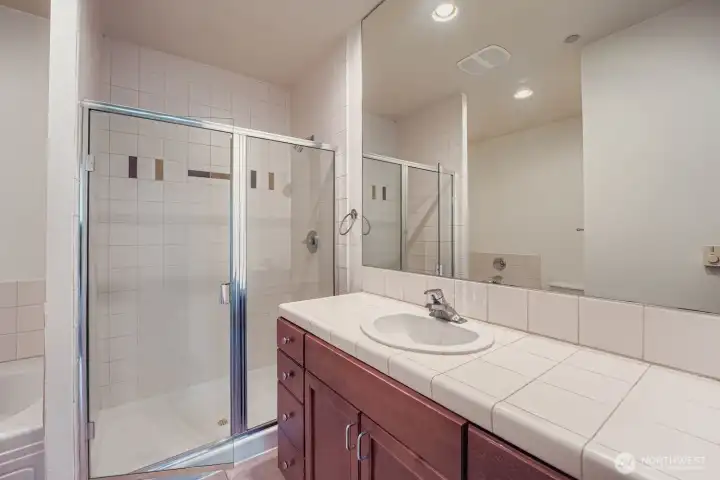 4-piece ensuite bath with bathtub, shower, toilet and vanity.