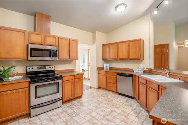 Beautiful hardwood cabinets and tiled flooring offer both classic style and everyday practicality.