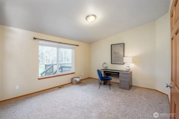 Office settled next to living room creates a nook of privacy with great space of storage or alternative uses.